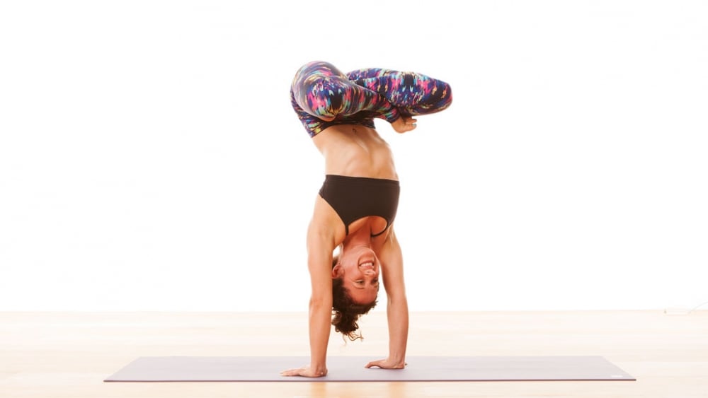 Woman in a yoga studio in a headstand pose - Stock Image - Everypixel