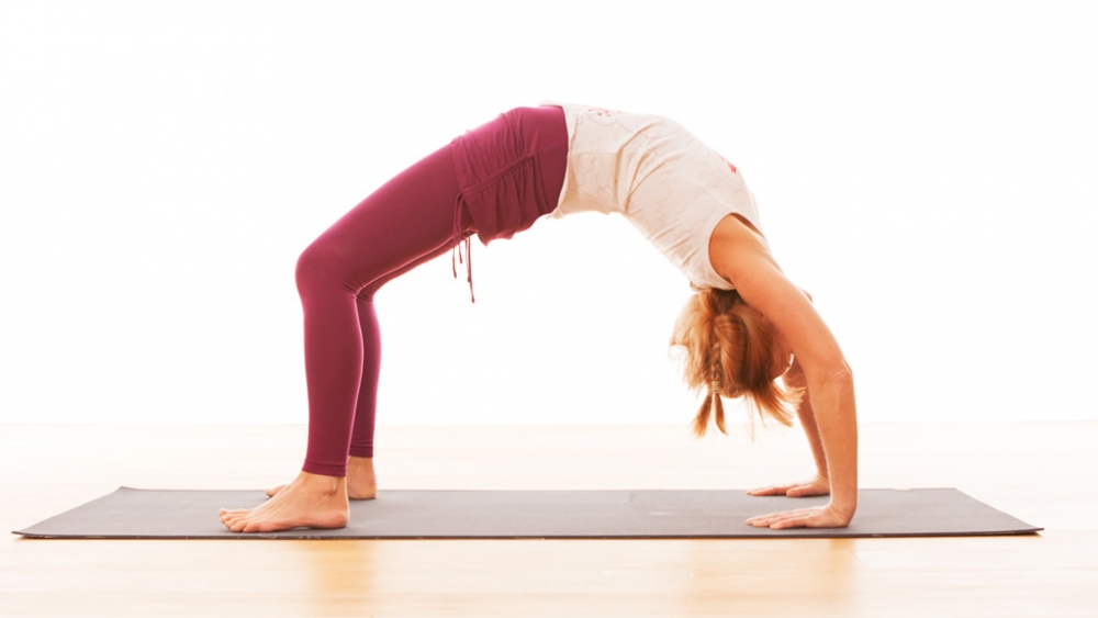 5 yoga wheel moves that will help you quit hunching