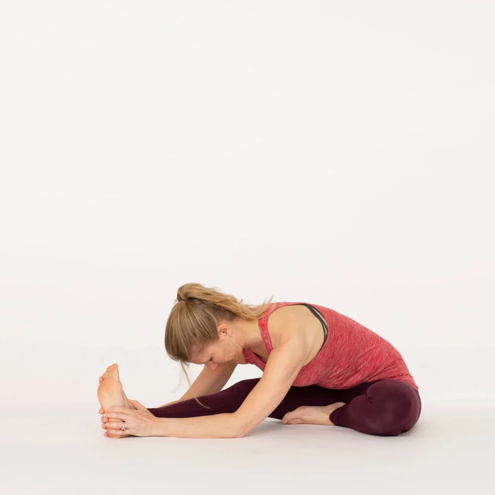 Marichi's yoga asana pose woman show on orange color background Stock Photo  - Alamy