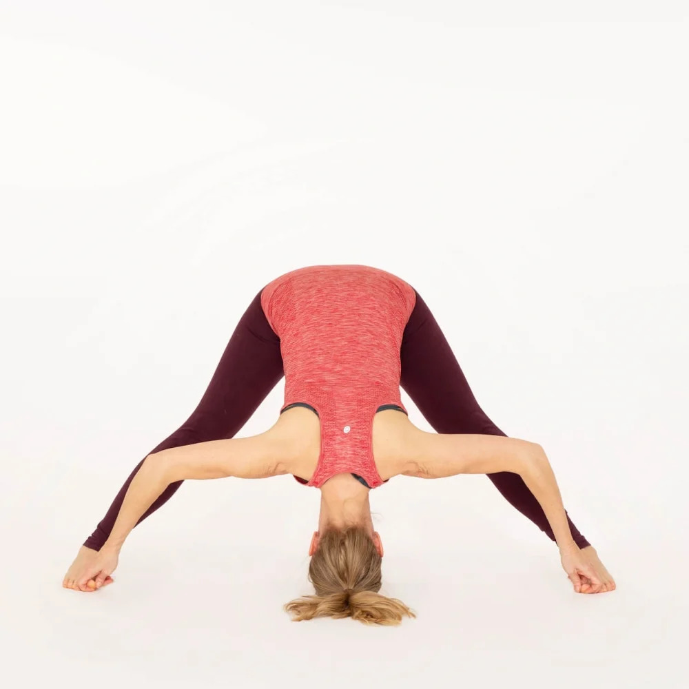 a 70 year old yoga instructor in her studio does Wide-Angle Seated Forward  Bend, aka Upavistha Konasana Stock Photo - Alamy